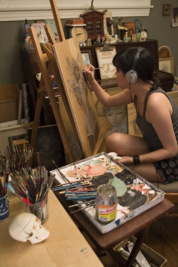 Artist at easel in studio